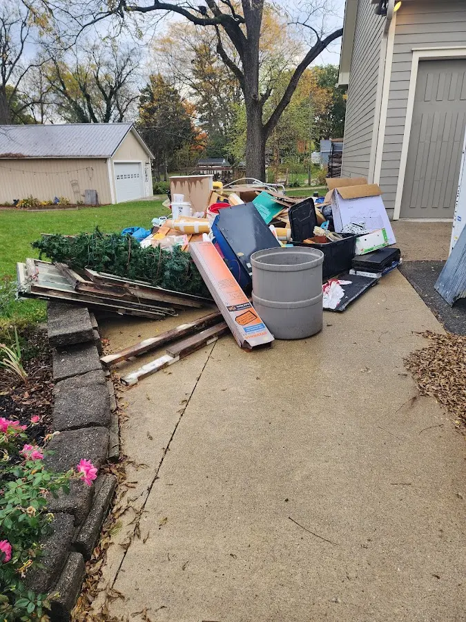 Dumpster being loaded with debris for Roofing Dumpster Rental in Dickinson